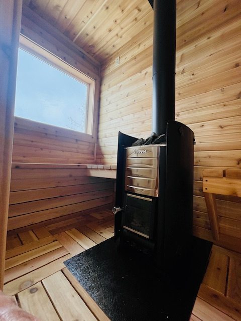 Warm wood-lined sauna with stove